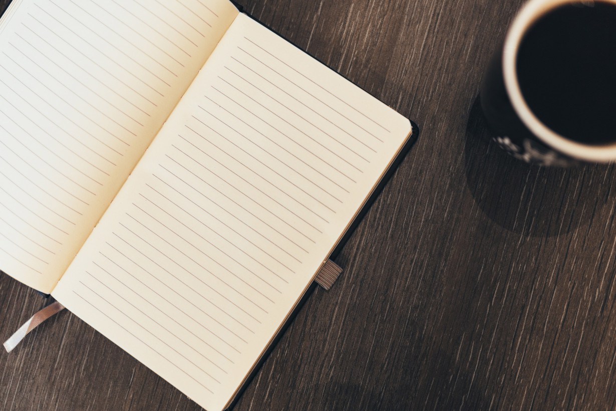 Notebook and coffee, mid-session